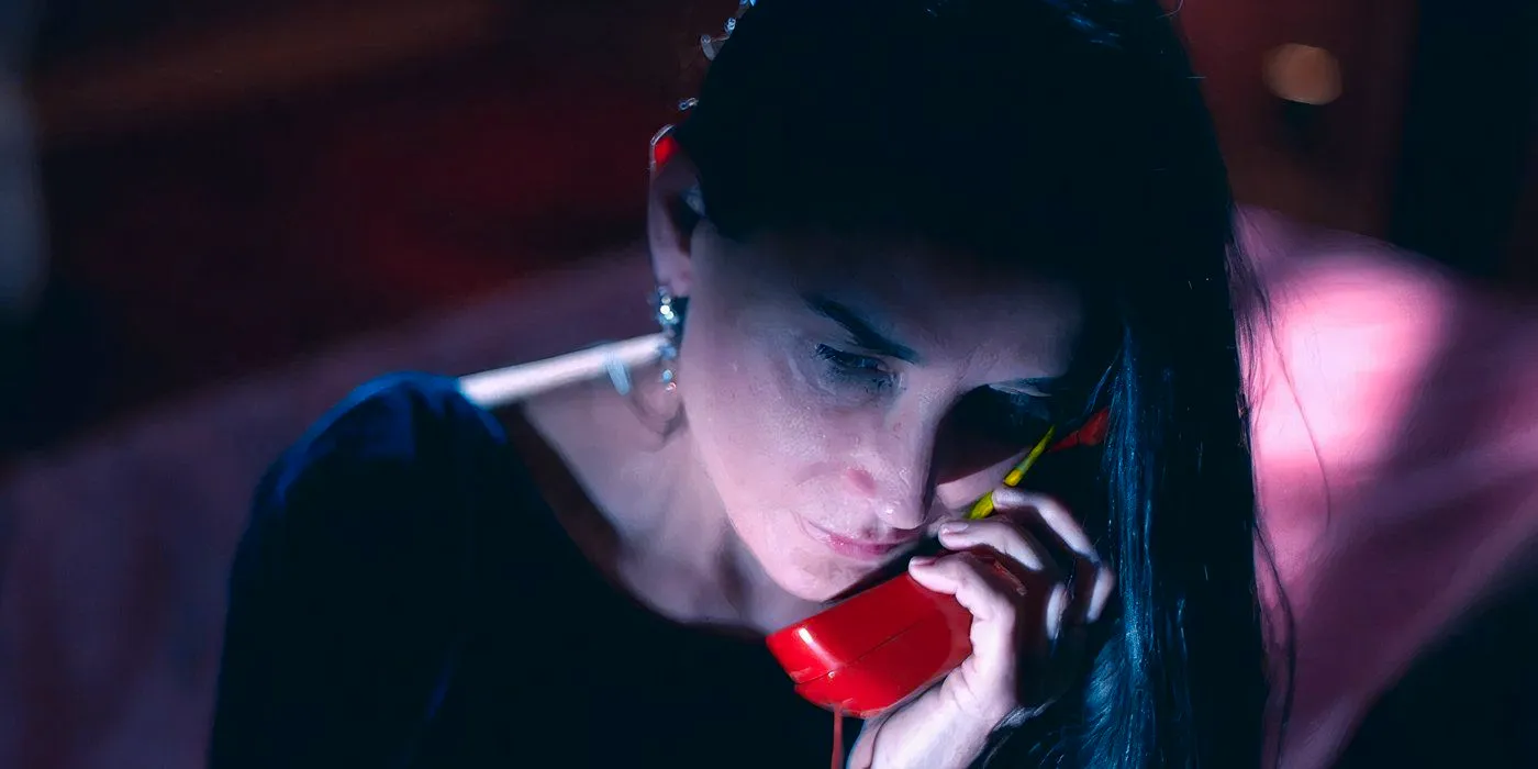 Demi Moore on the phone in The Substance movie still Image