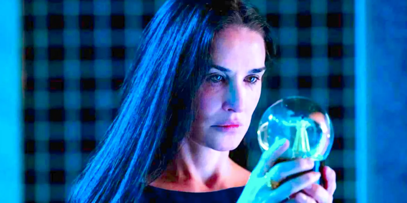 Demi Moore's Elizabeth stares at a snow globe in The Substance Image