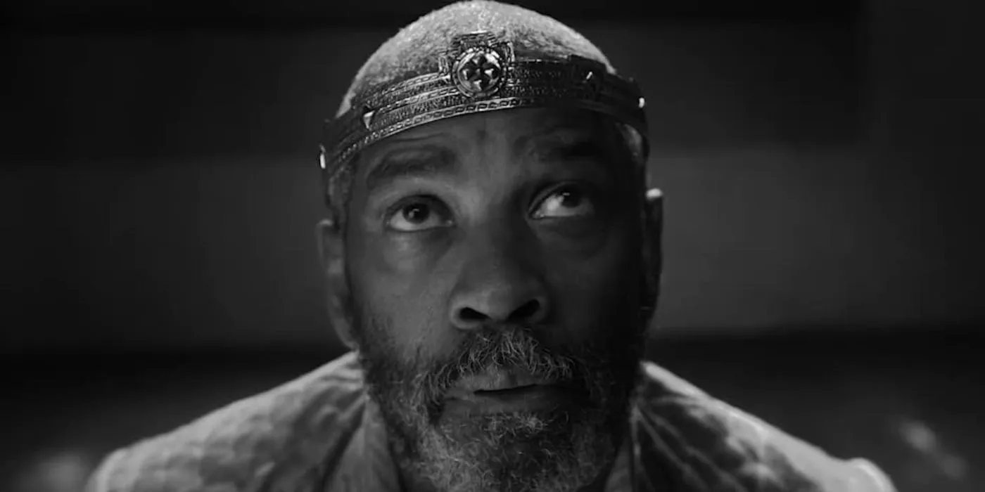 Denzel Washington as Macbeth looking upwards at the witches in The Tragedy of Macbeth Image