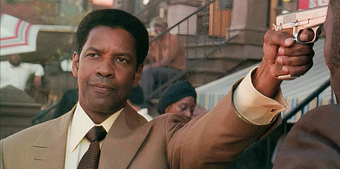 denzel Washington's frank lucas aiming a gun in american gangster Image