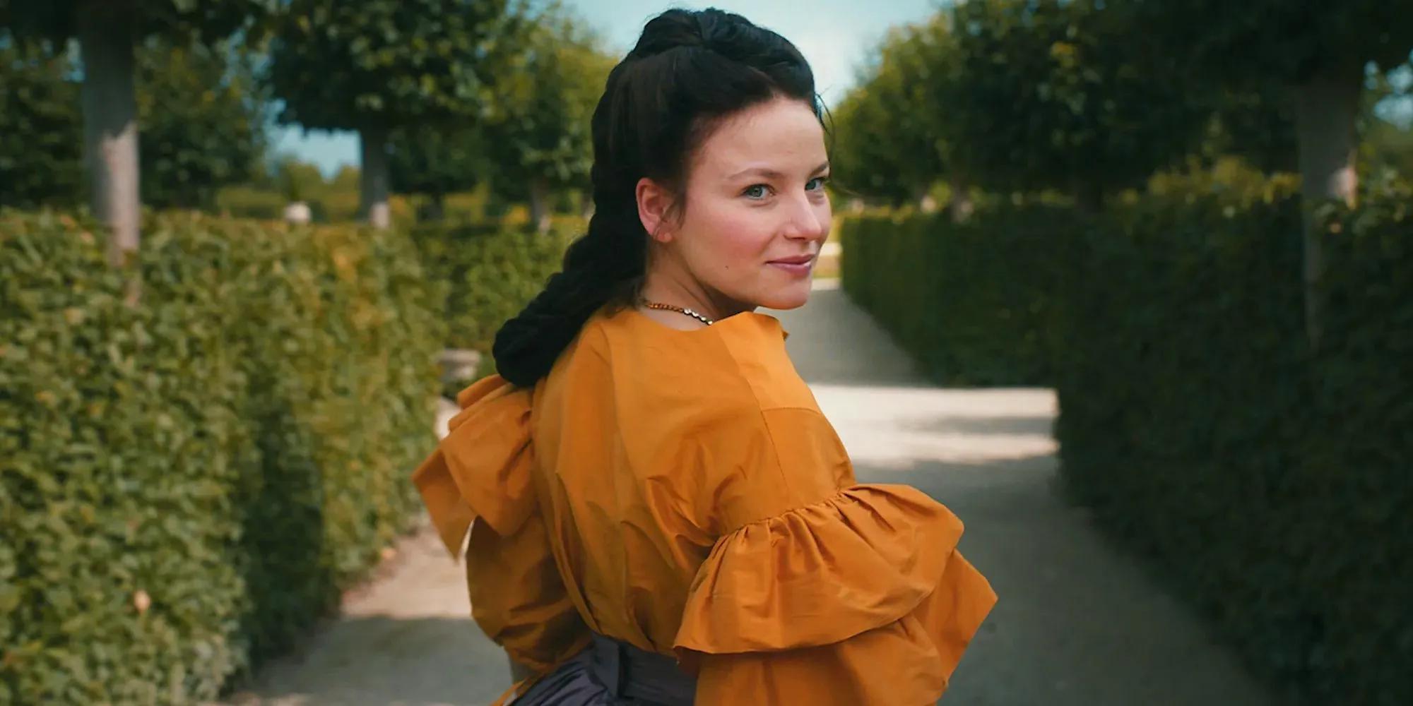 Devrim Lingnau looks behind while at the garden in The Empress Image