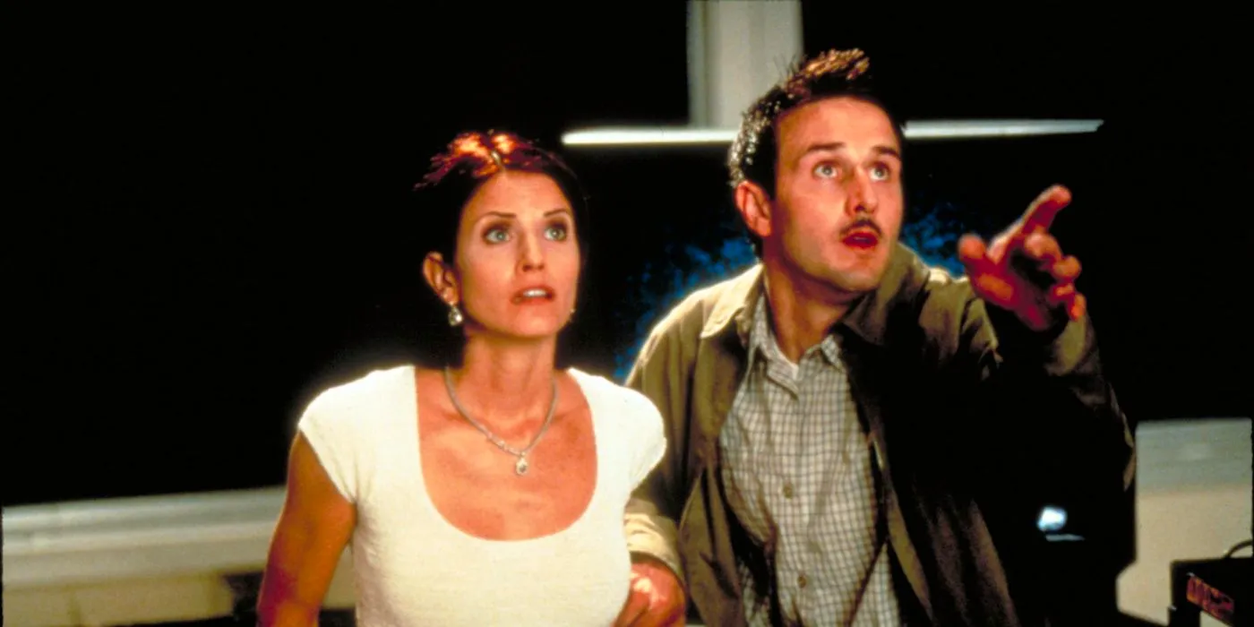 Dewey and Gale looking up at the killer in Scream 2 Image