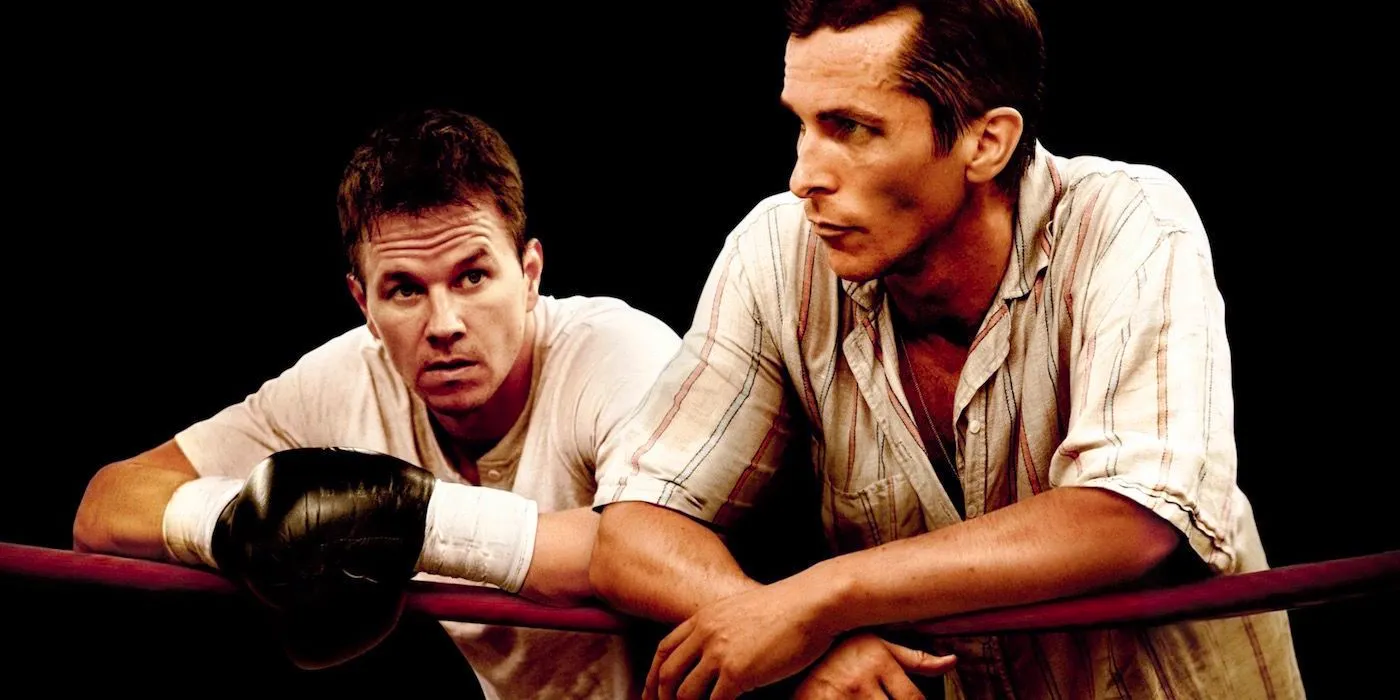 Dicky Ecklund (Christian Bale) and Micky Ward (Mark Wahlberg) leaning against the ropes in a ring in The Fighter Image