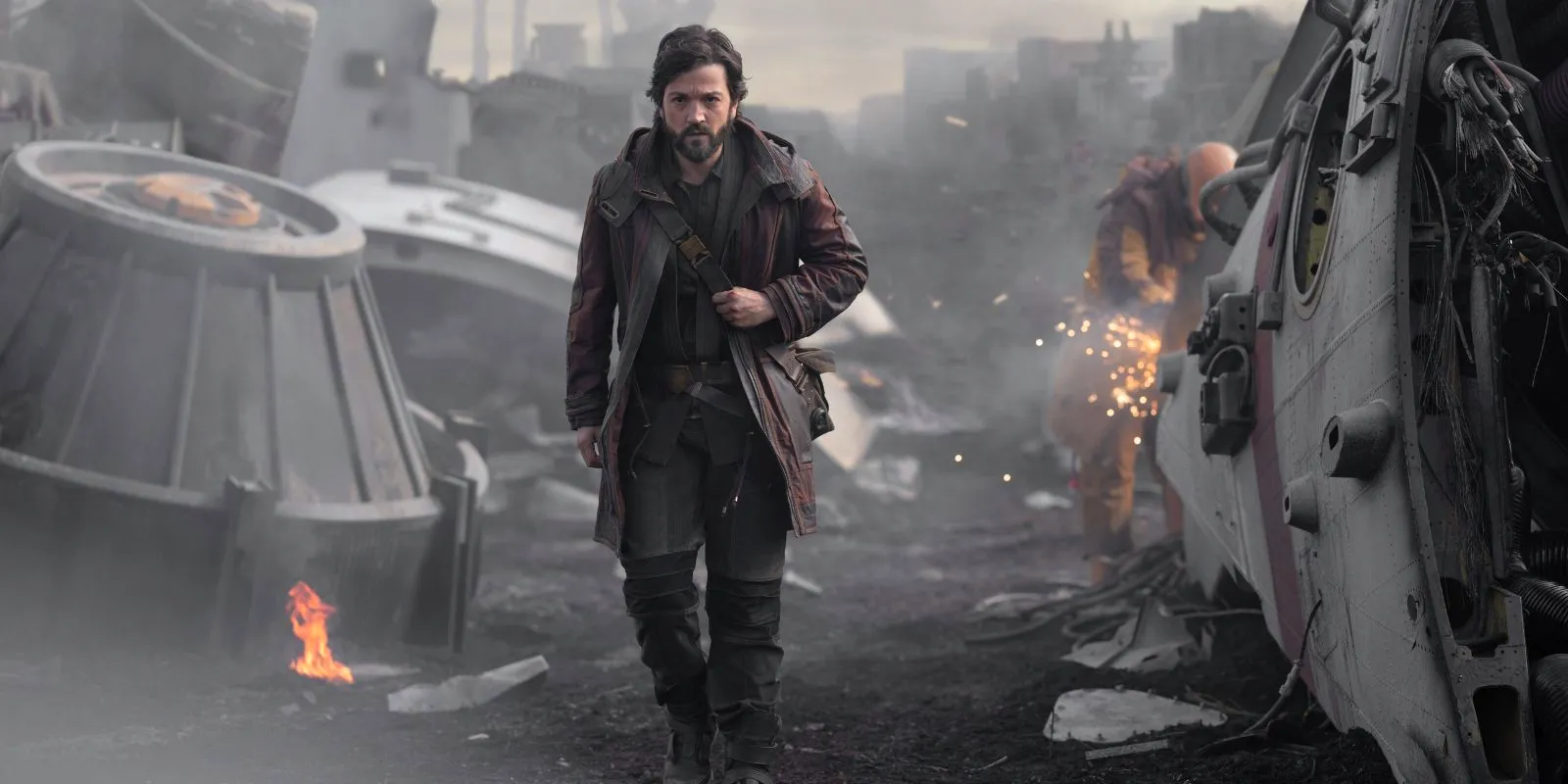 Diego Luna as Cassian Andor walking through a junkyard in Andor Image