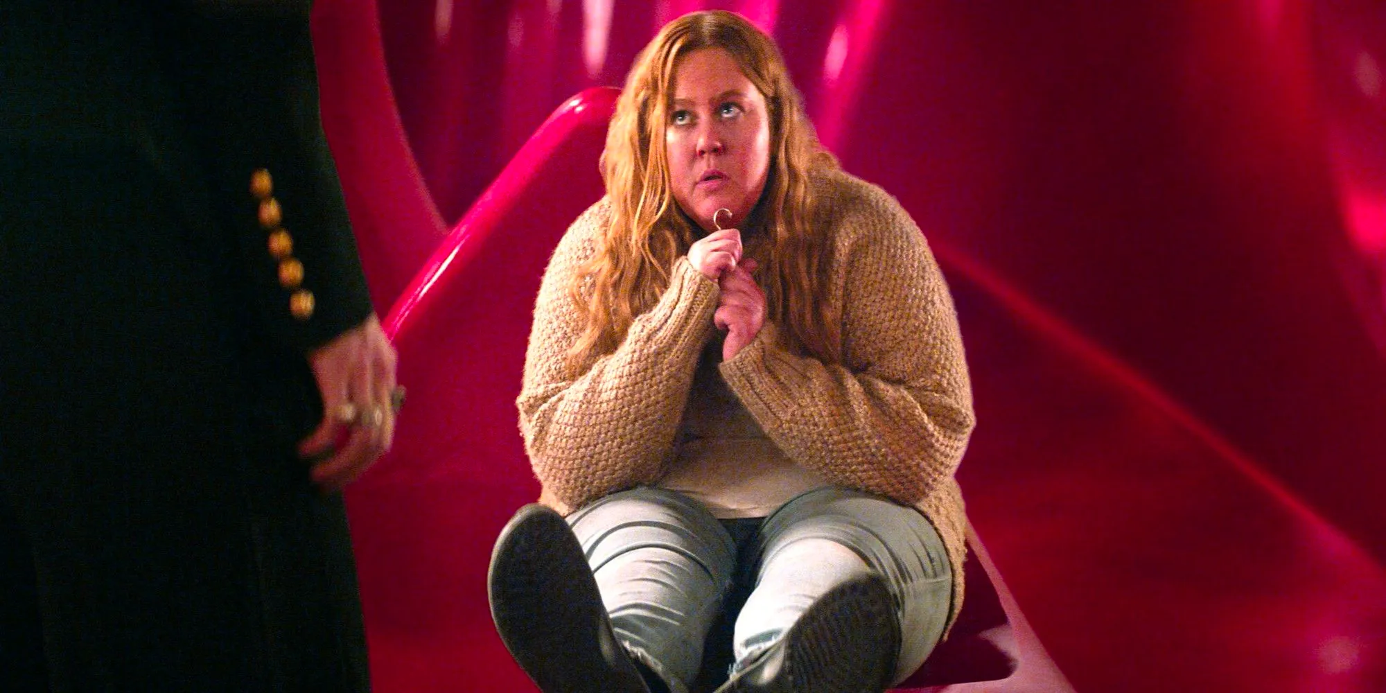 Donna Preston as Despair sitting on the floor and looking up in The Sandman on Netflix Image