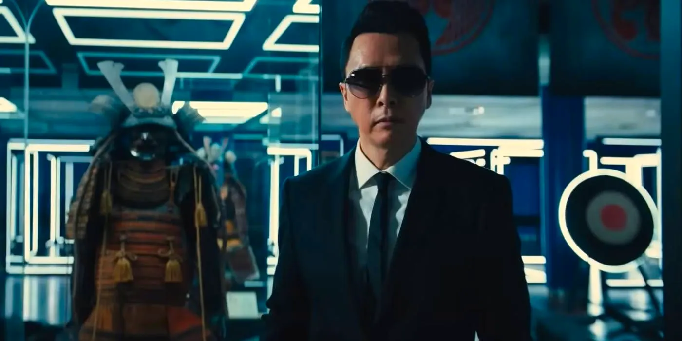 Donnie Yen as Caine standing next to samurai armor in John Wick Chapter 4 Image