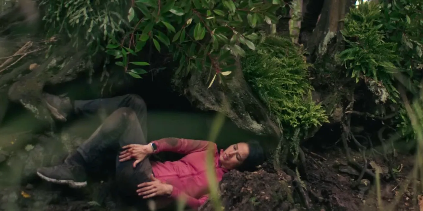 Don't Move Kelsey Asbille sitting on the forest floor struggling  Image