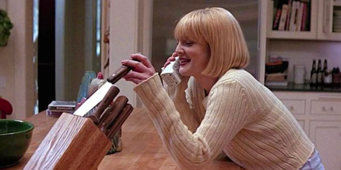 Drew Barrymore as Casey talking on the phone and playing with some knives in Scream. Image