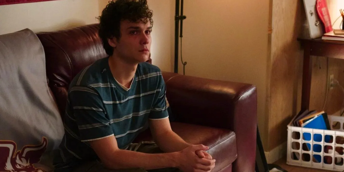 Drew looking serious sitting on a couch in Tell Me Lies Image