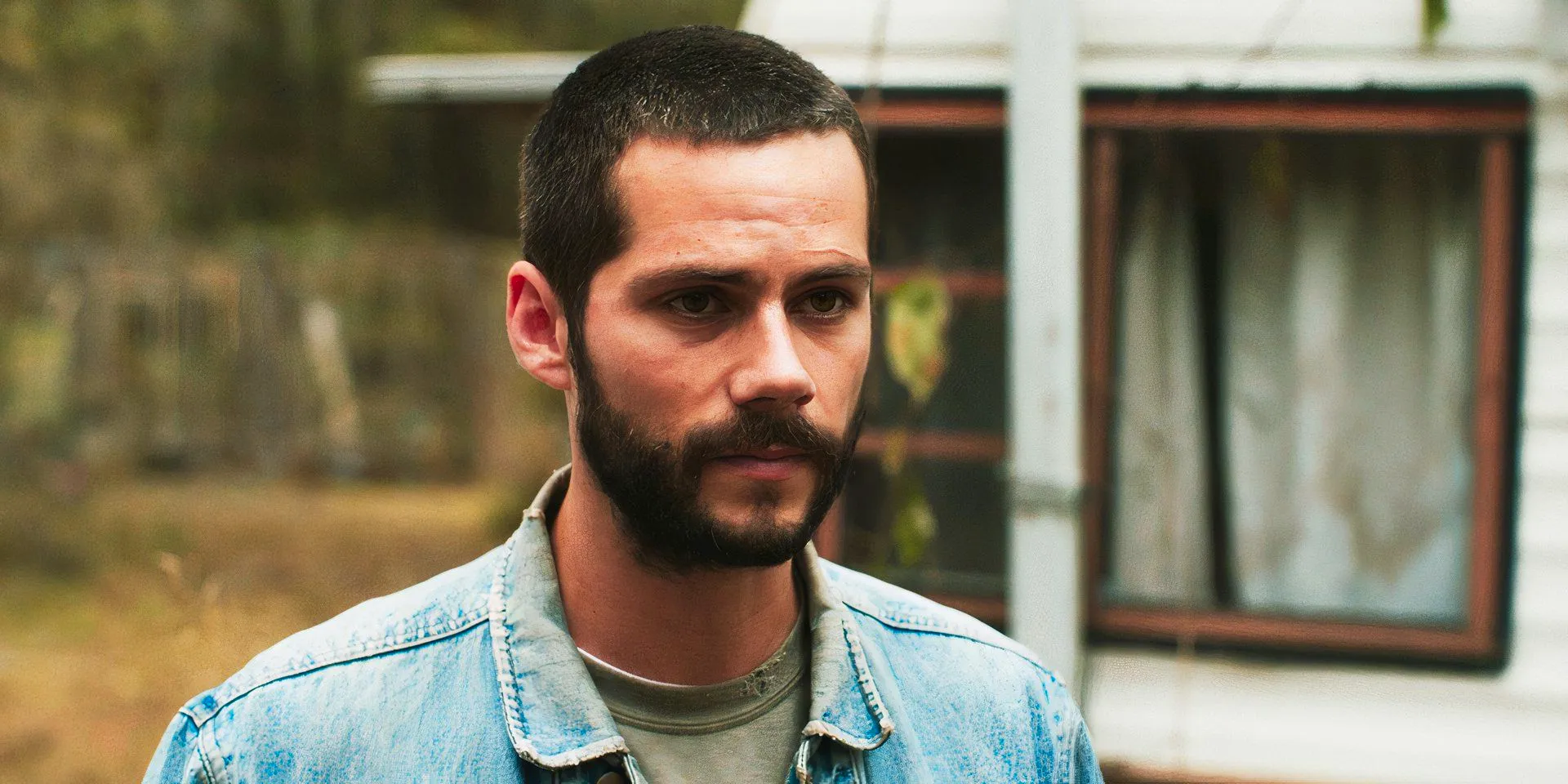 Dylan O'Brien staring at someone, as Paris, in Caddo Lake Image