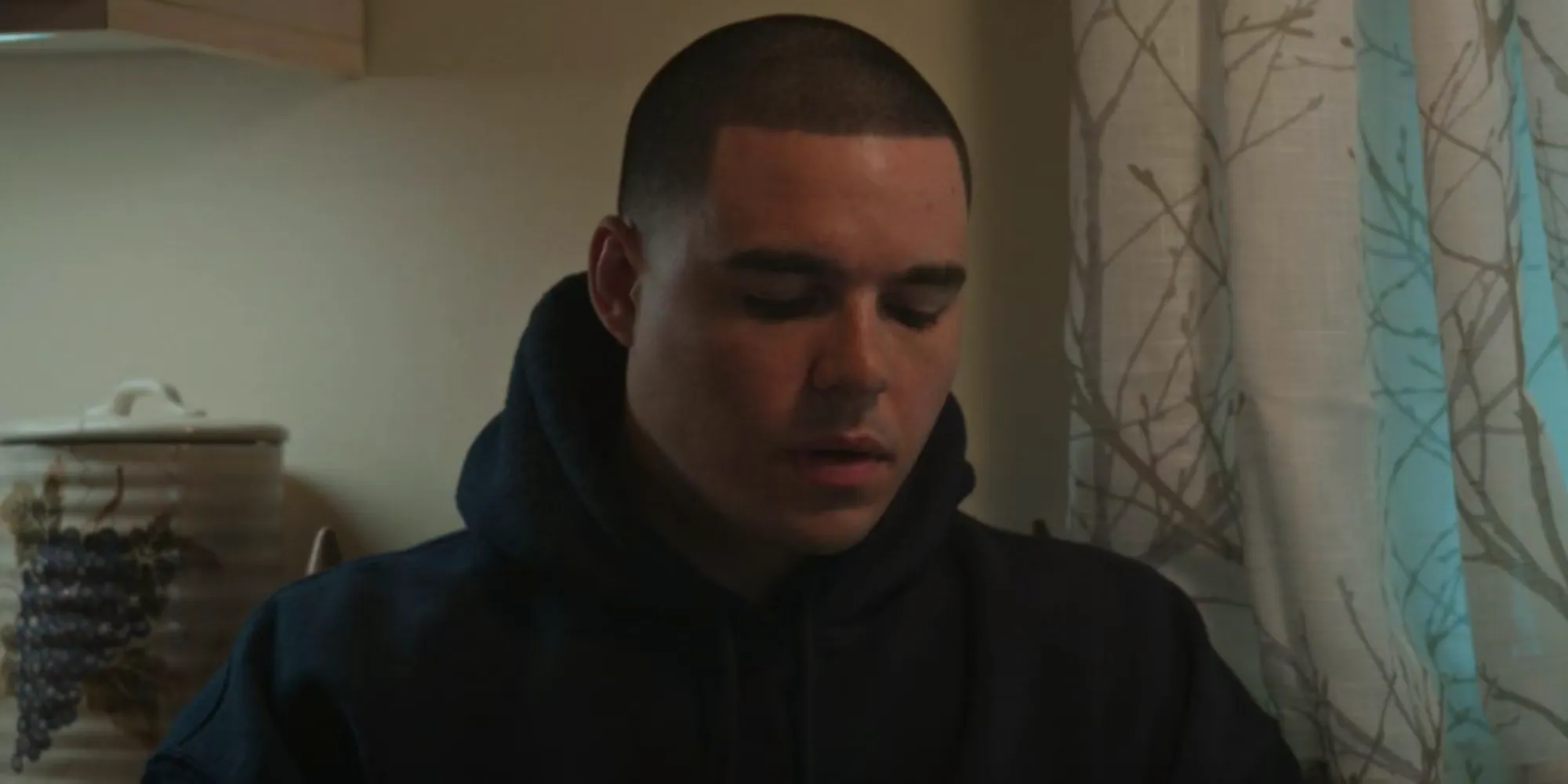 Ean Castellanos looking sad as DJ Hernandez in American Sports Story: Aaron Hernandez Image