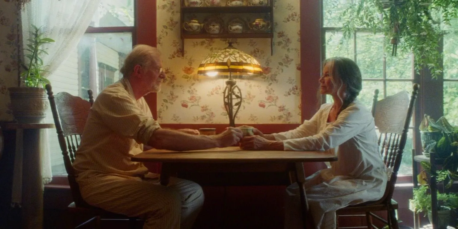 Ed Begley Jr as Frederick and Barbara Hershey as Genevieve sitting at the breakfast table in Strange Darling Image