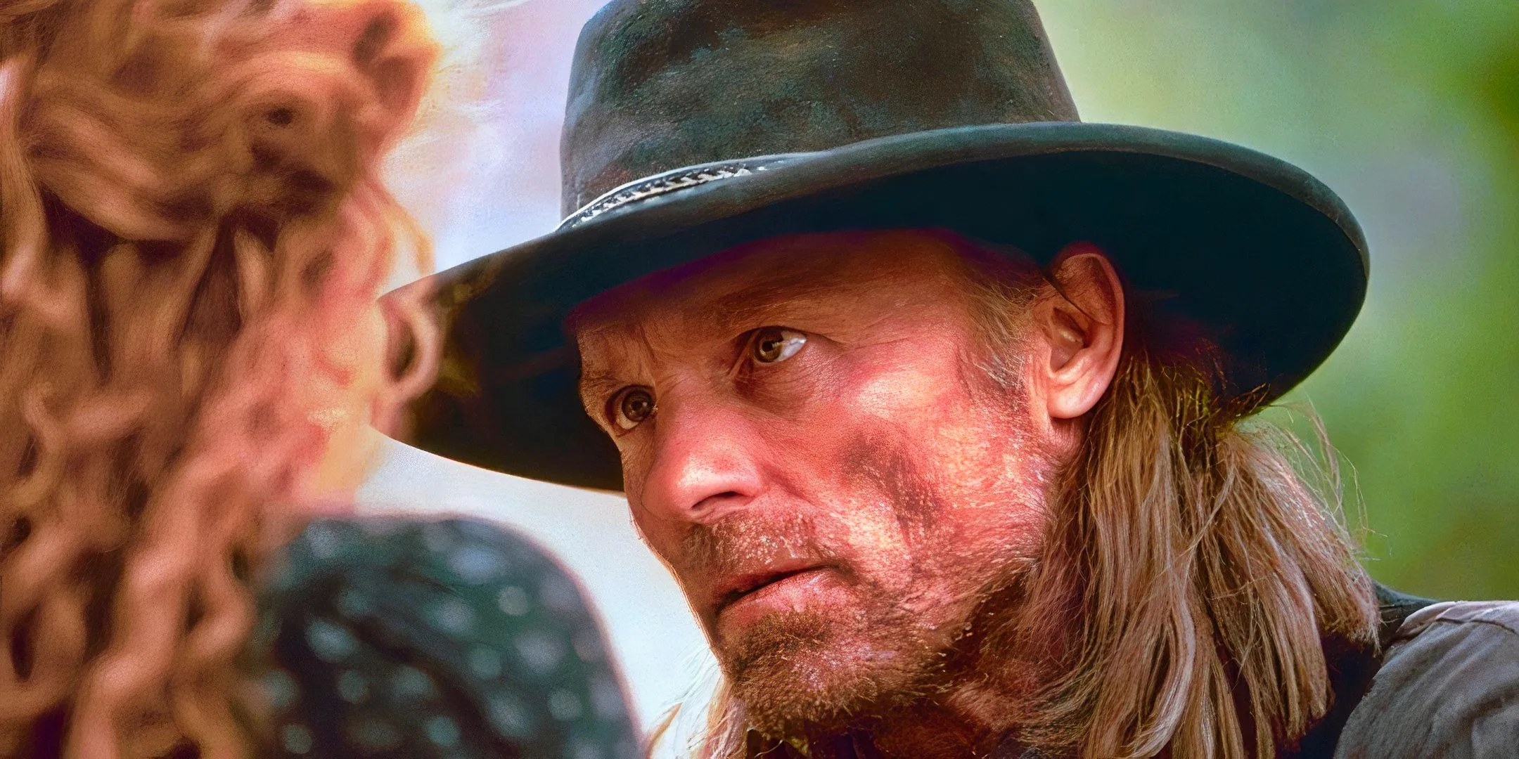 Ed Harris looks up at a woman with concern in Riders of the Purple Sage.  Image