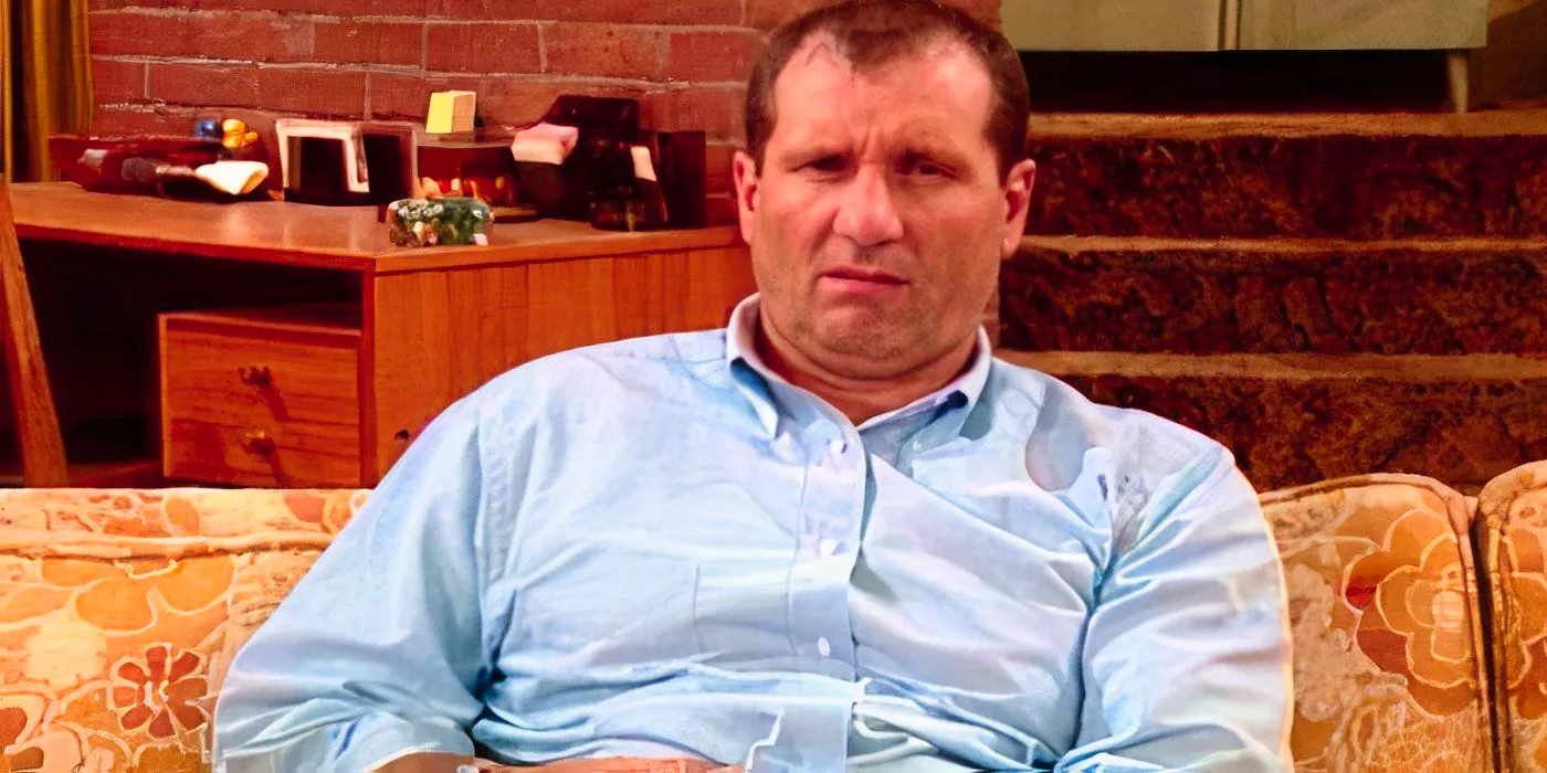 Ed O'Neill as Al Bundy looking grumpy on the couch in Married with Children. Image