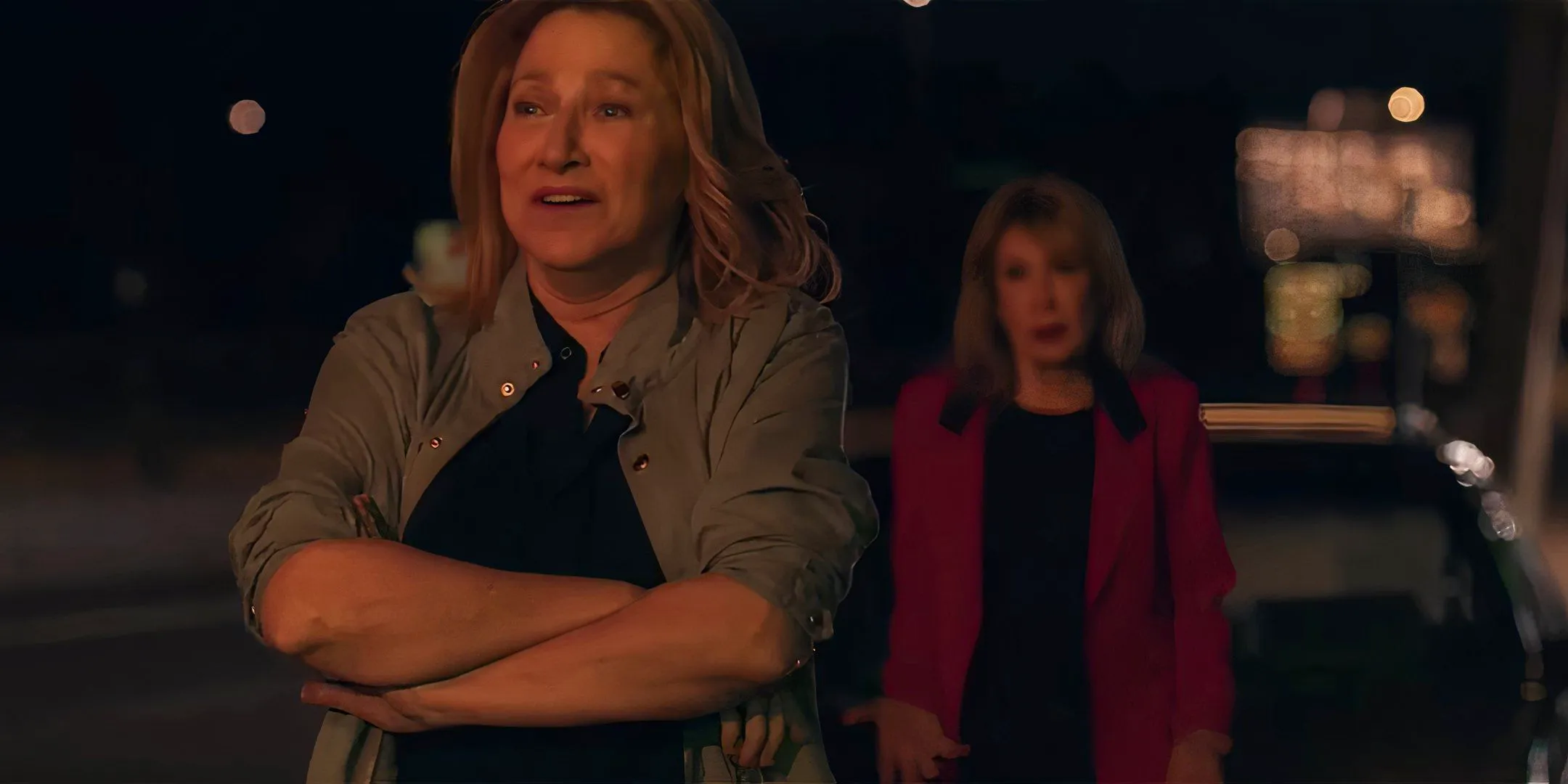 Edie Falco as Wanda looking distressed with her mom in the background in I'll Be Right There Image