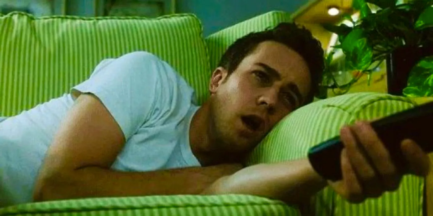 Edward Norton with his mouth hanging open and holding a remote control in Fight Club Image