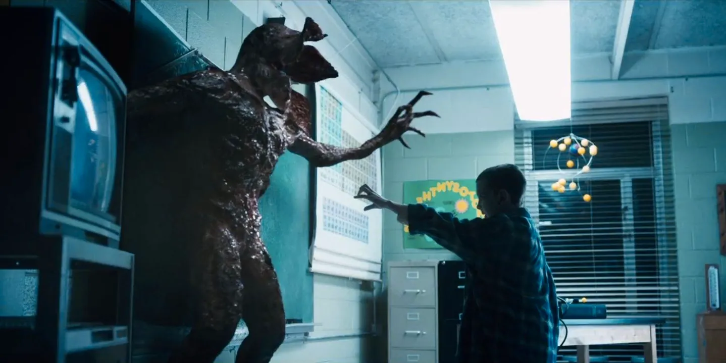 Eleven fighting the Demogorgon in a classroom in Stranger Things Image