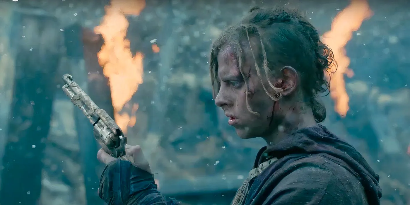 Eli finds a gun in the rubble in Into The Badlands, as a fire burns in the background. Image