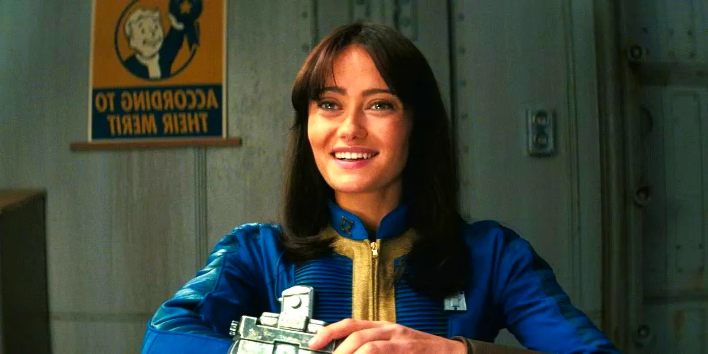 Ella Purnell as Lucy MacLean smiling while sitting at a table in the Fallout show Image