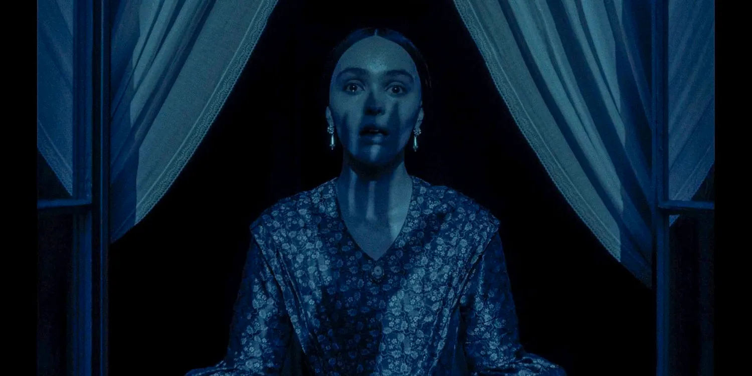 Ellen Hutter (Lily-Rose Depp) looking shocked with the shadow of a sinister hand cast upon her face in Nosferatu Image