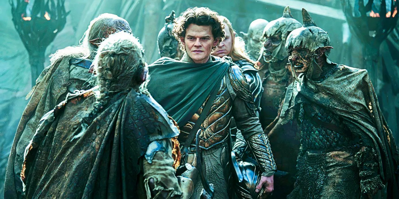 Elrond stands among a group of Orcs looking dirty from battle in Rings of Power Image