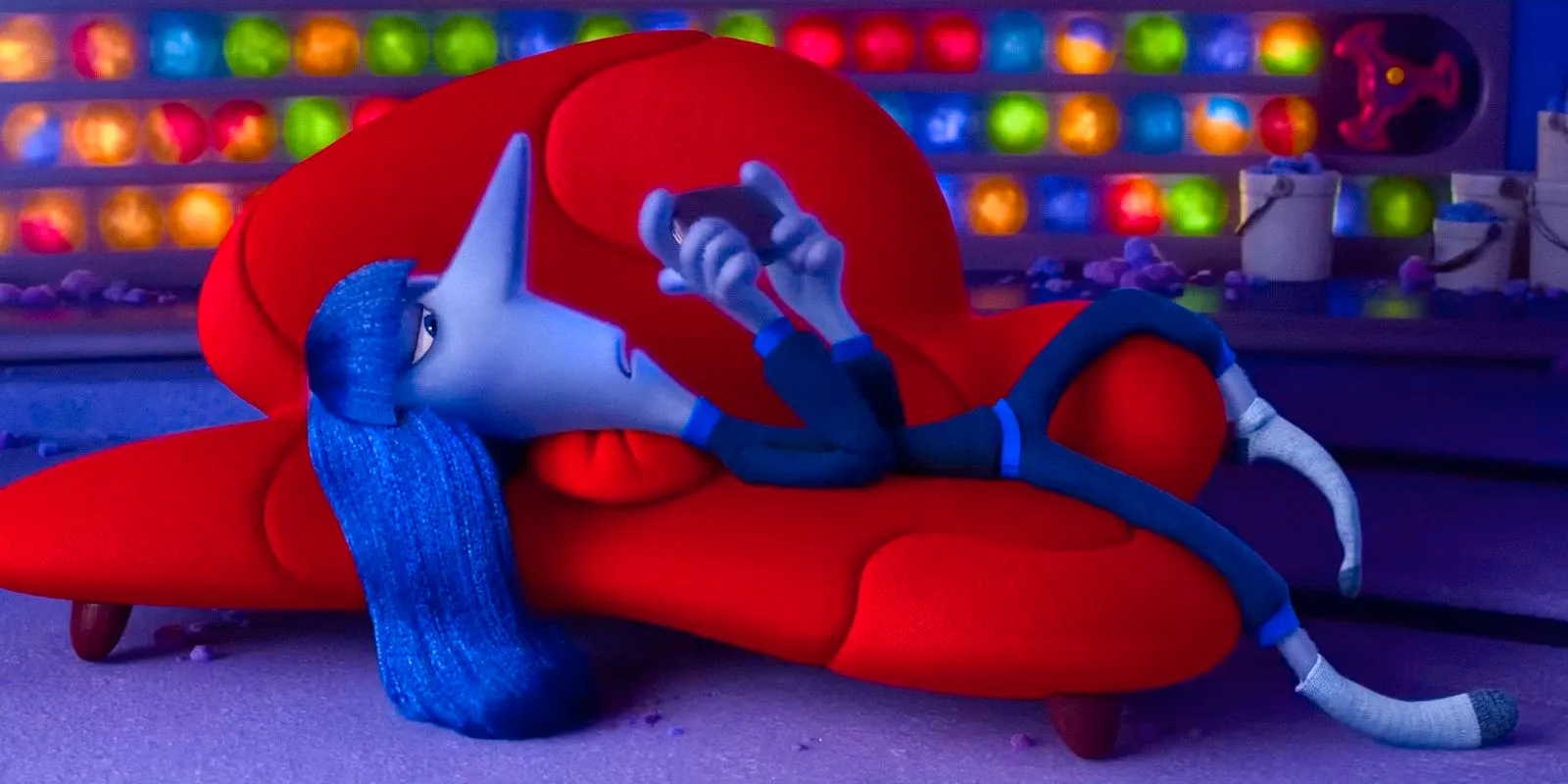 Ennui lying on the couch, passing the time on the phone in Inside Out 2 Image