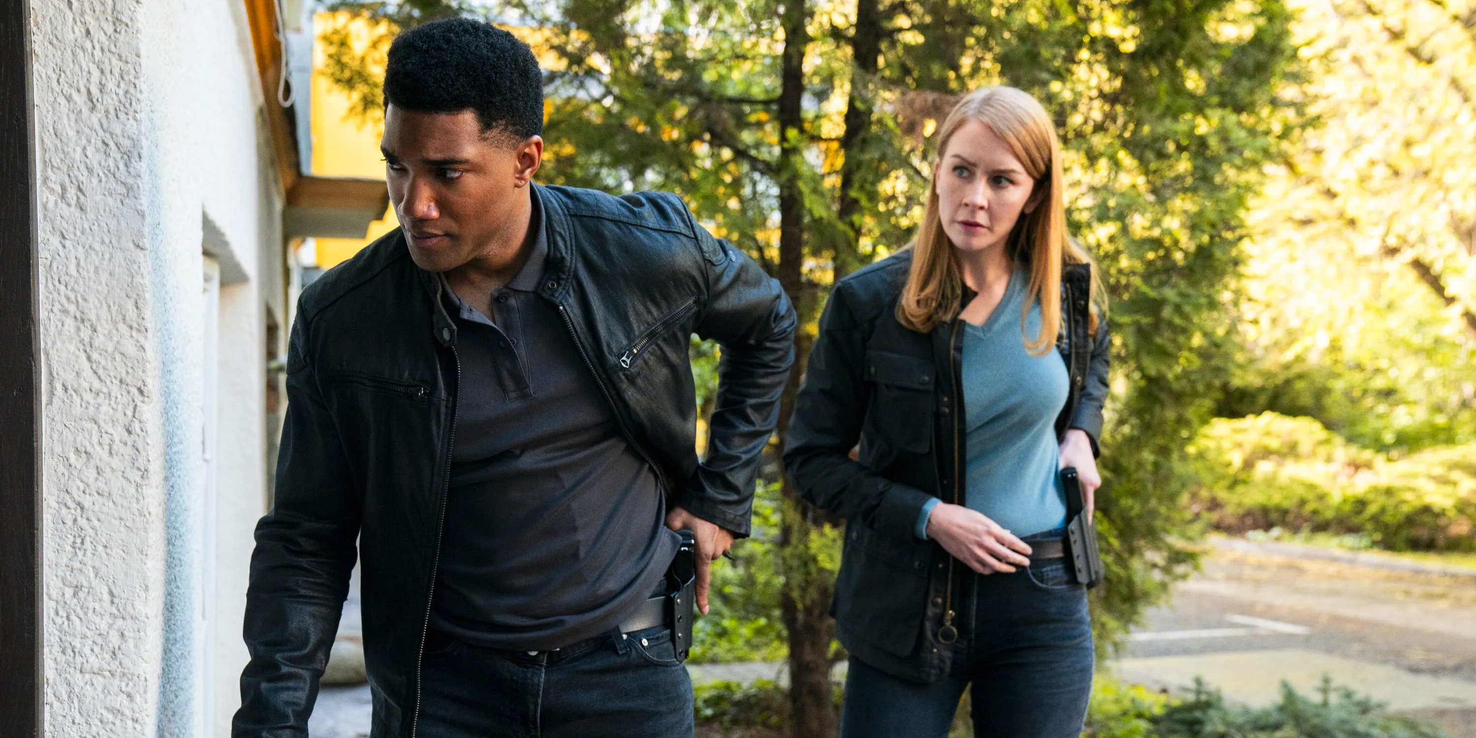 Eva-Jane Willis as Europol Agent Megan “Smitty” Garretson and Carter Redwood as Special Agent Andre Raines approaching a door in FBI: International season 3, episode 11 Image