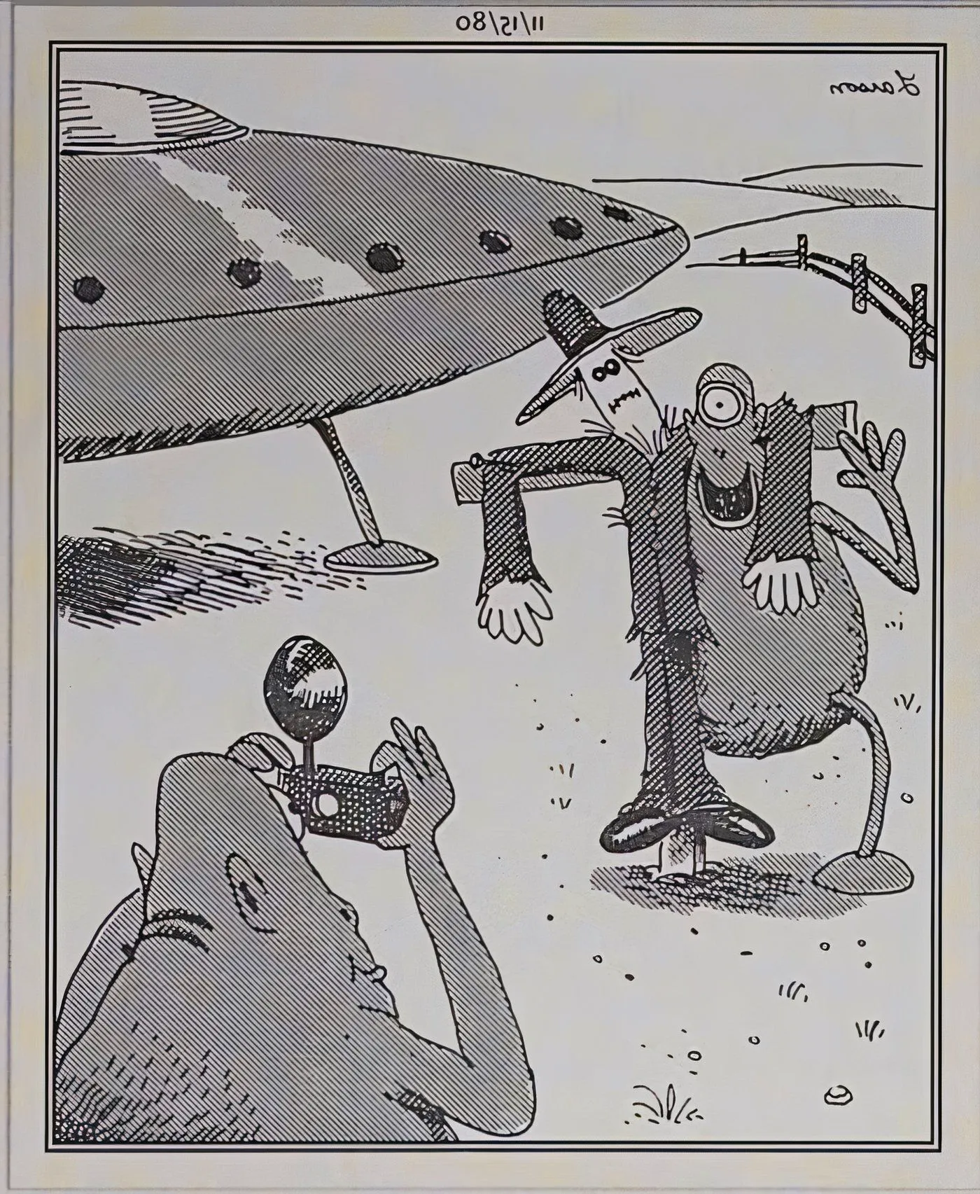 Far Side aliens taking pictures with a scarecrow.  Image