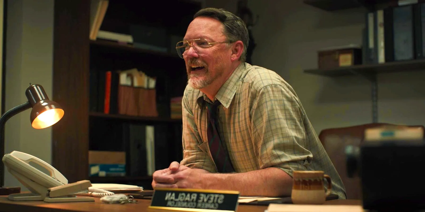 Five Nights at Freddy's Matthew Lillard at Steve Raglan sitting at desk while smiling  Image