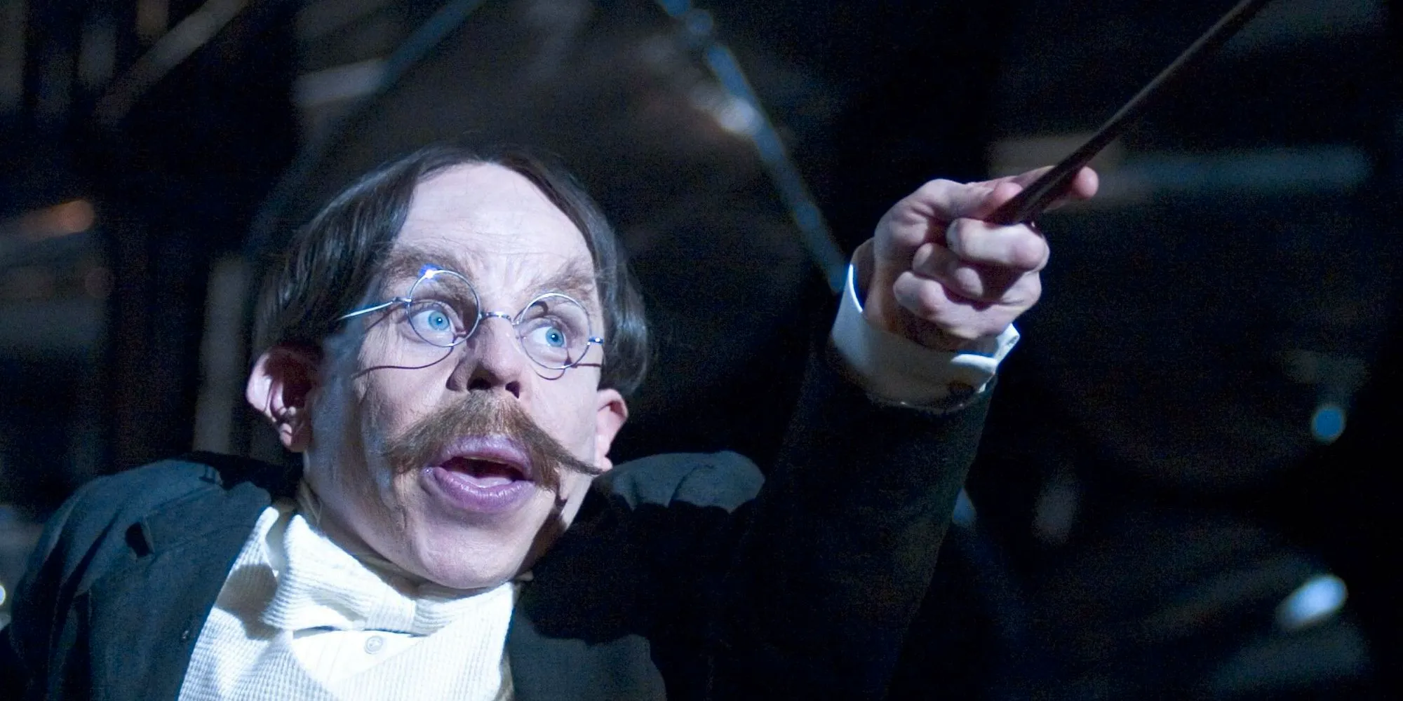 Flitwick pointing his wand at something Image