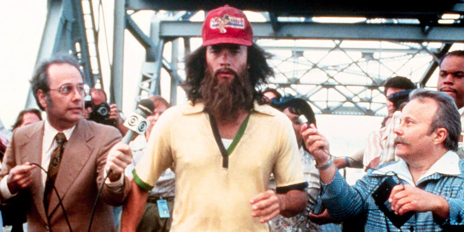 Forrest running with news reporters in Forrest Gump Image