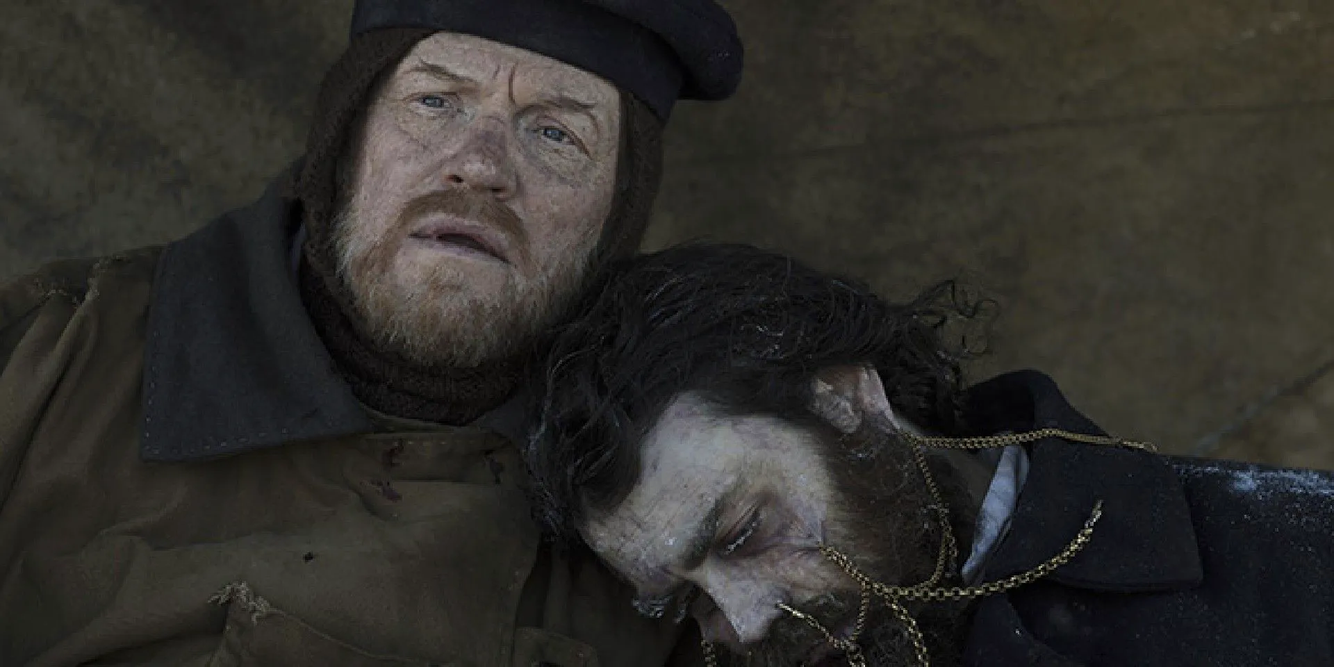 Francis Crozier, played by Jared Harris, holds the dead Edward Little in The Terror, after discovering him with mysterious gold piercings in his face. Image