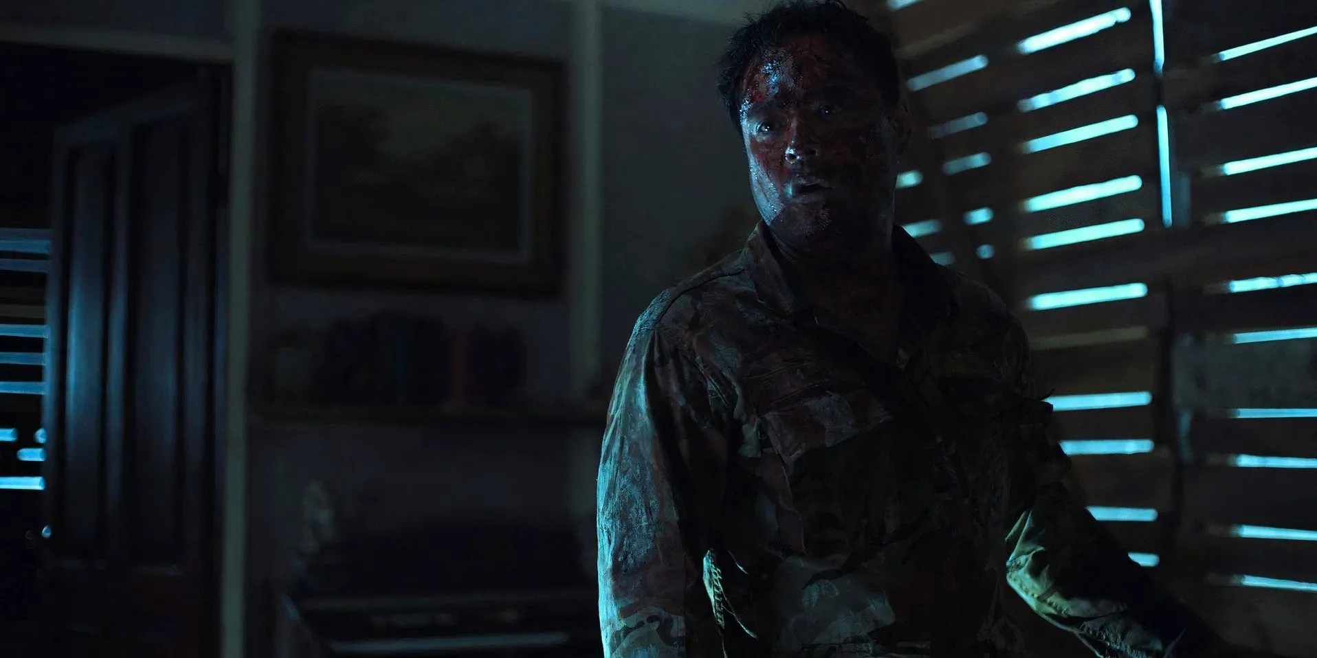 Francis (Sid Lucero) wearing a soldier's uniform and covered in blood in Outside Image