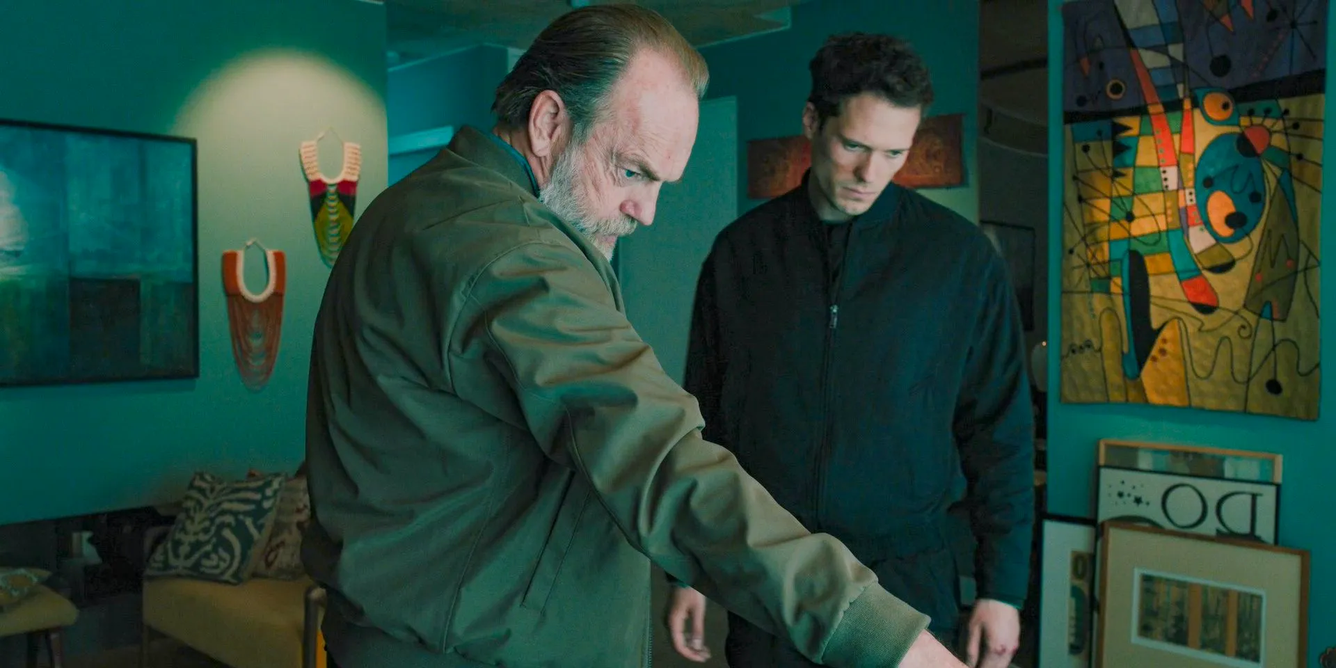 Frank Harkness (Hugo Weaving) giving instructions to Patrice (Tom Wozniczka) to intercept the van transporting River in Slow Horses Season 4 Episode 5 Image