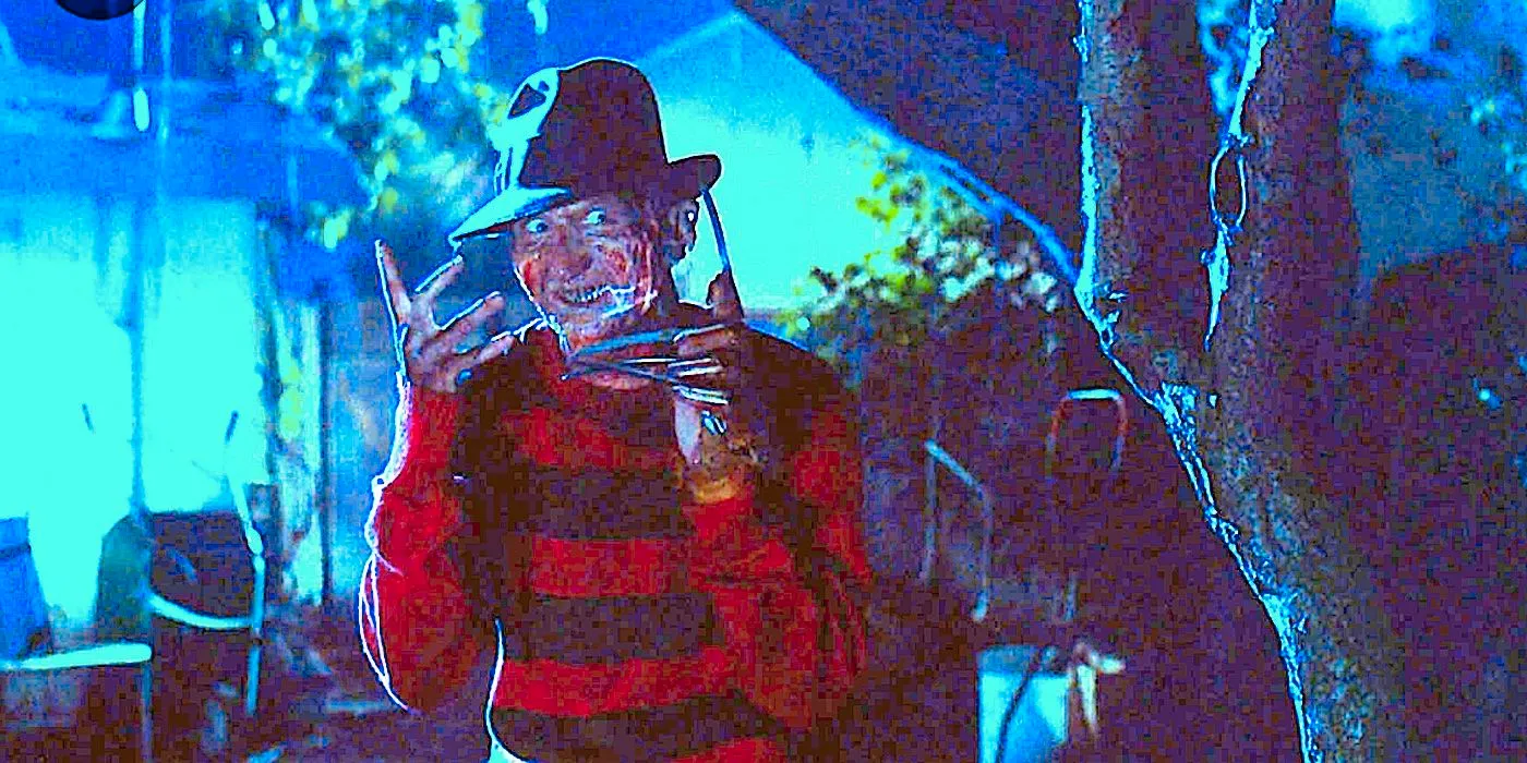 Freddy Krueger (Robert Englund) stands beside a tree grinning in Nightmare On Elm Street Image