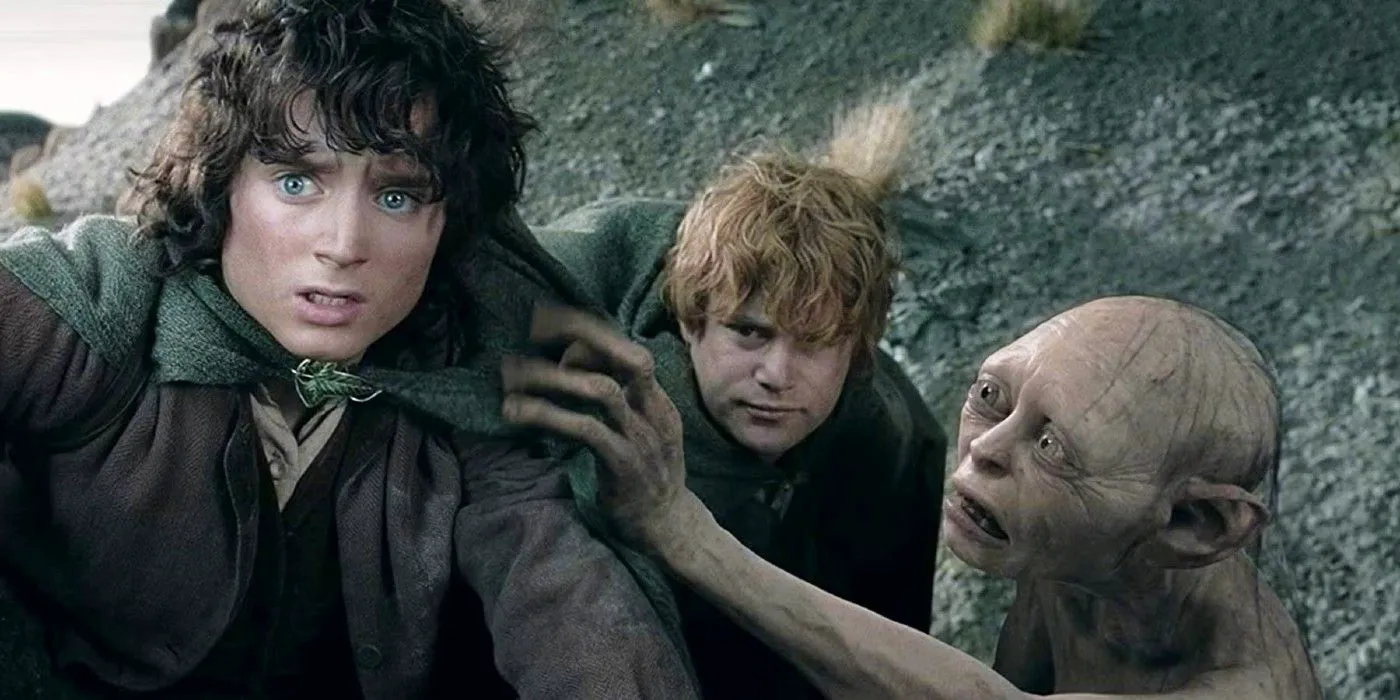 Frodo, Sam, and Gollum crouched on a mountainside in Lord of the Rings Image