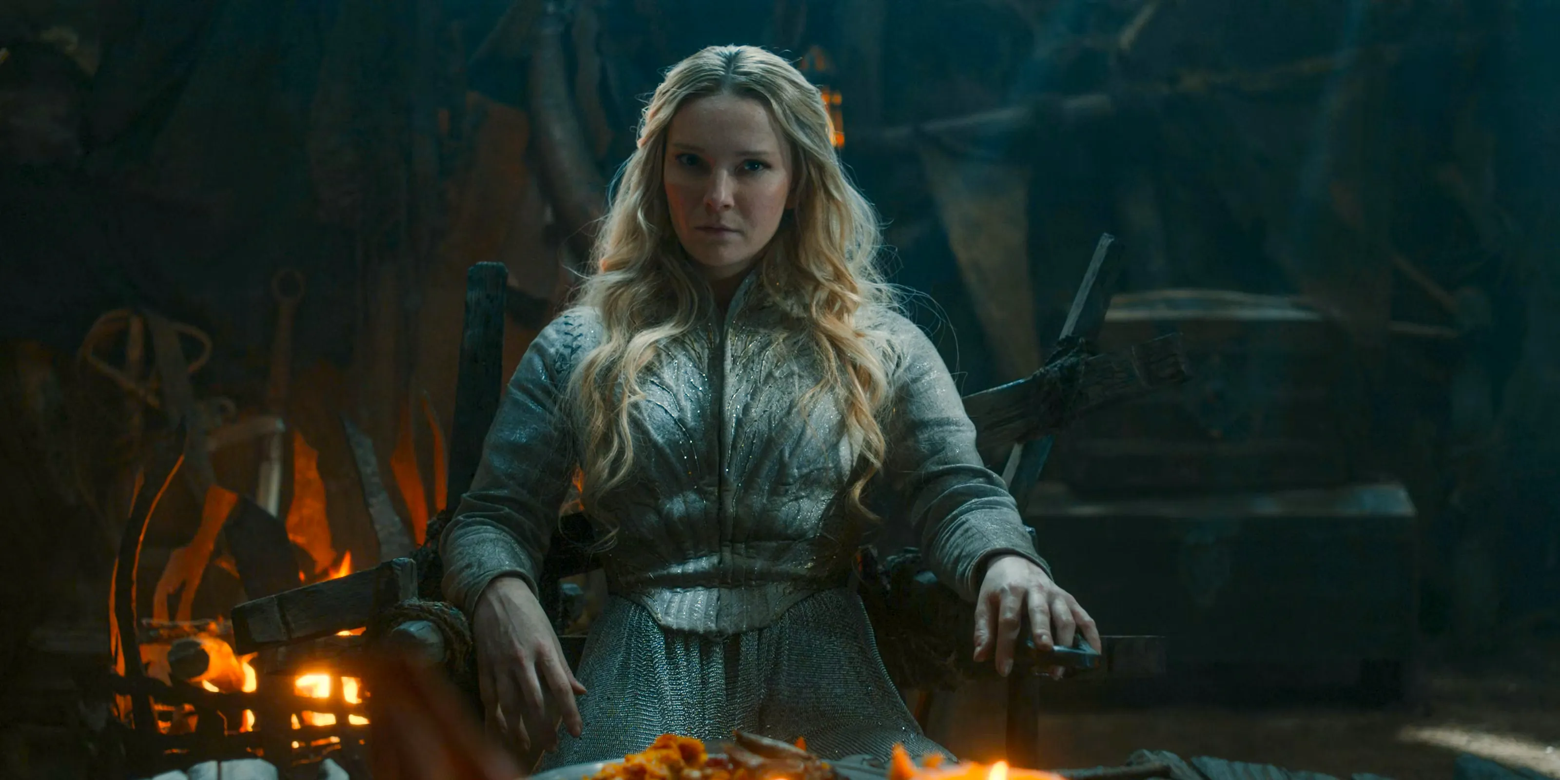 Galadriel (Morfydd Clark) dining with Adar as his prisoner in The Lord of the Rings: The Rings of Power Season 2 Episode 6 Image