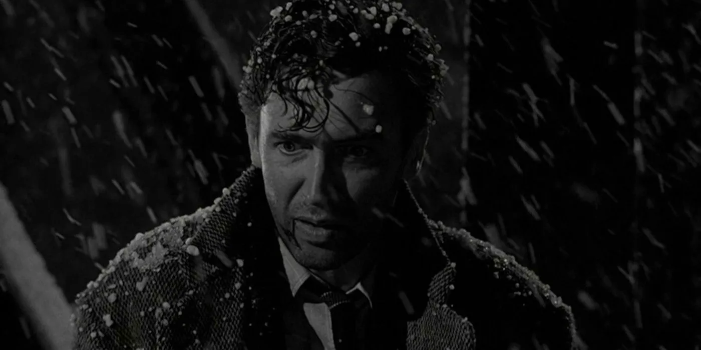 George Bailey standing on a bridge in the snow in It's a Wonderful Life Image