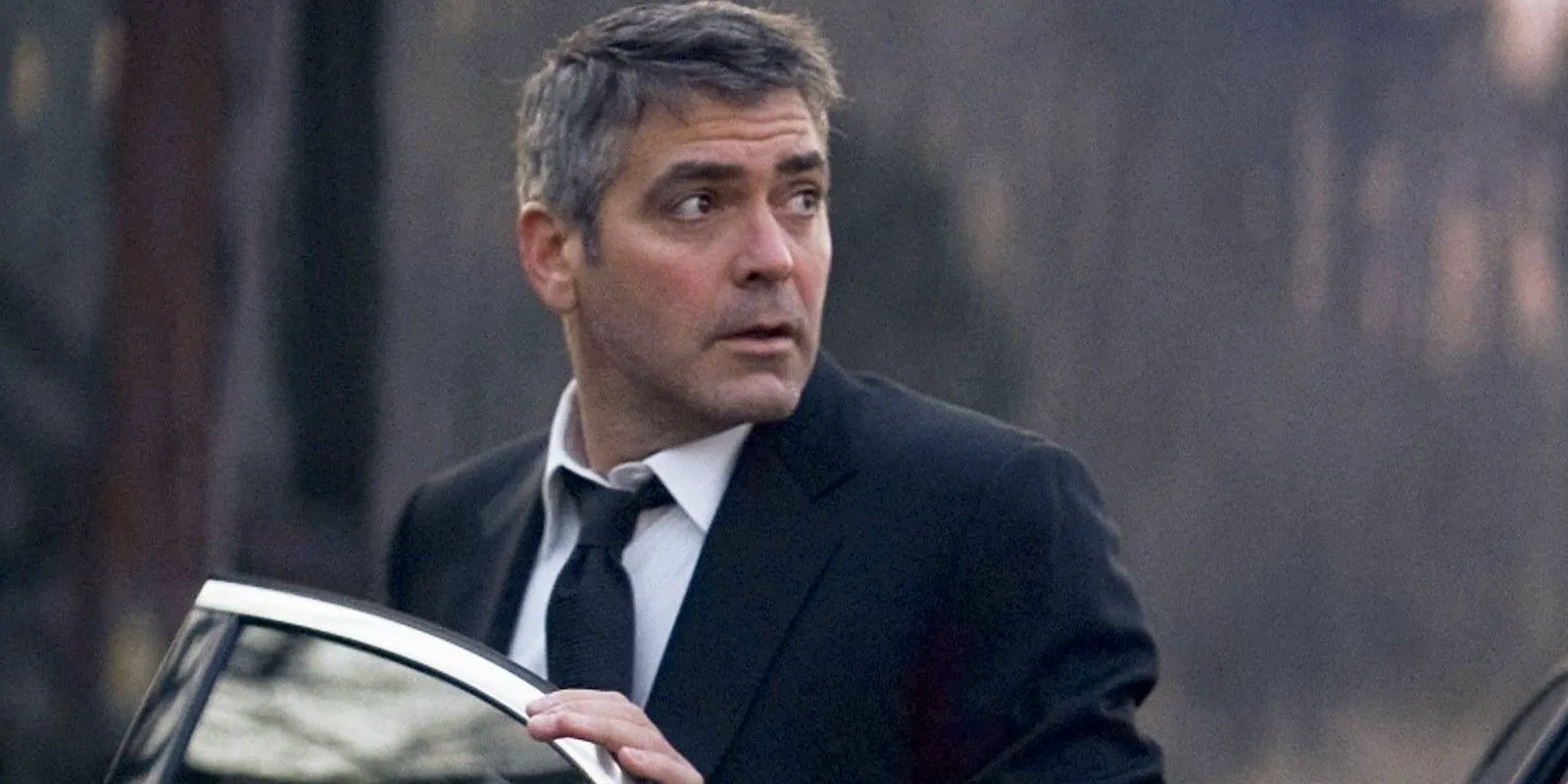 George Clooney looking surprised outside his car in Michael Clayton Image