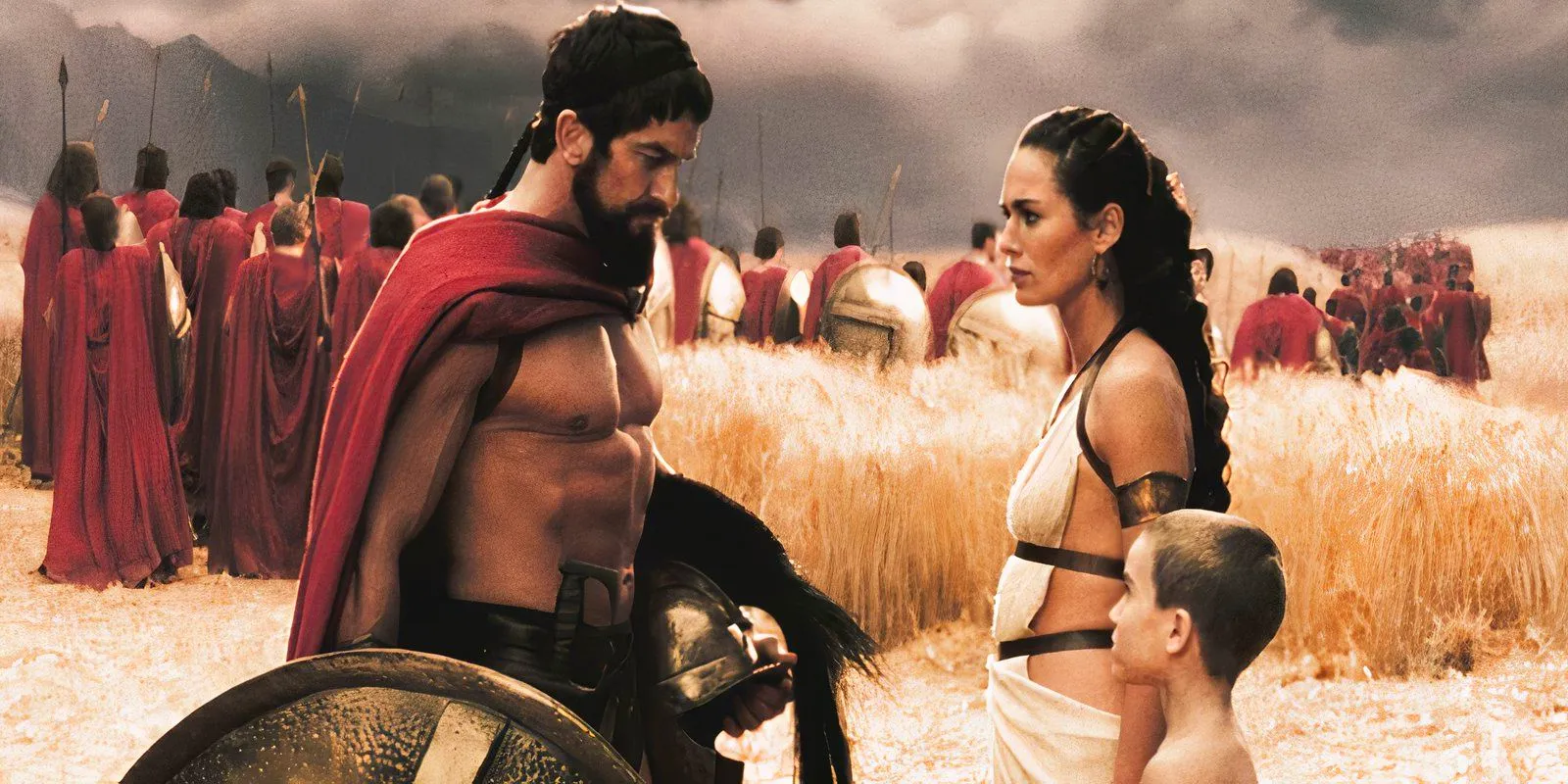 Gerard Butler as Leonidas stands with Lena Headey as Gorgo with their young son in 300 Image