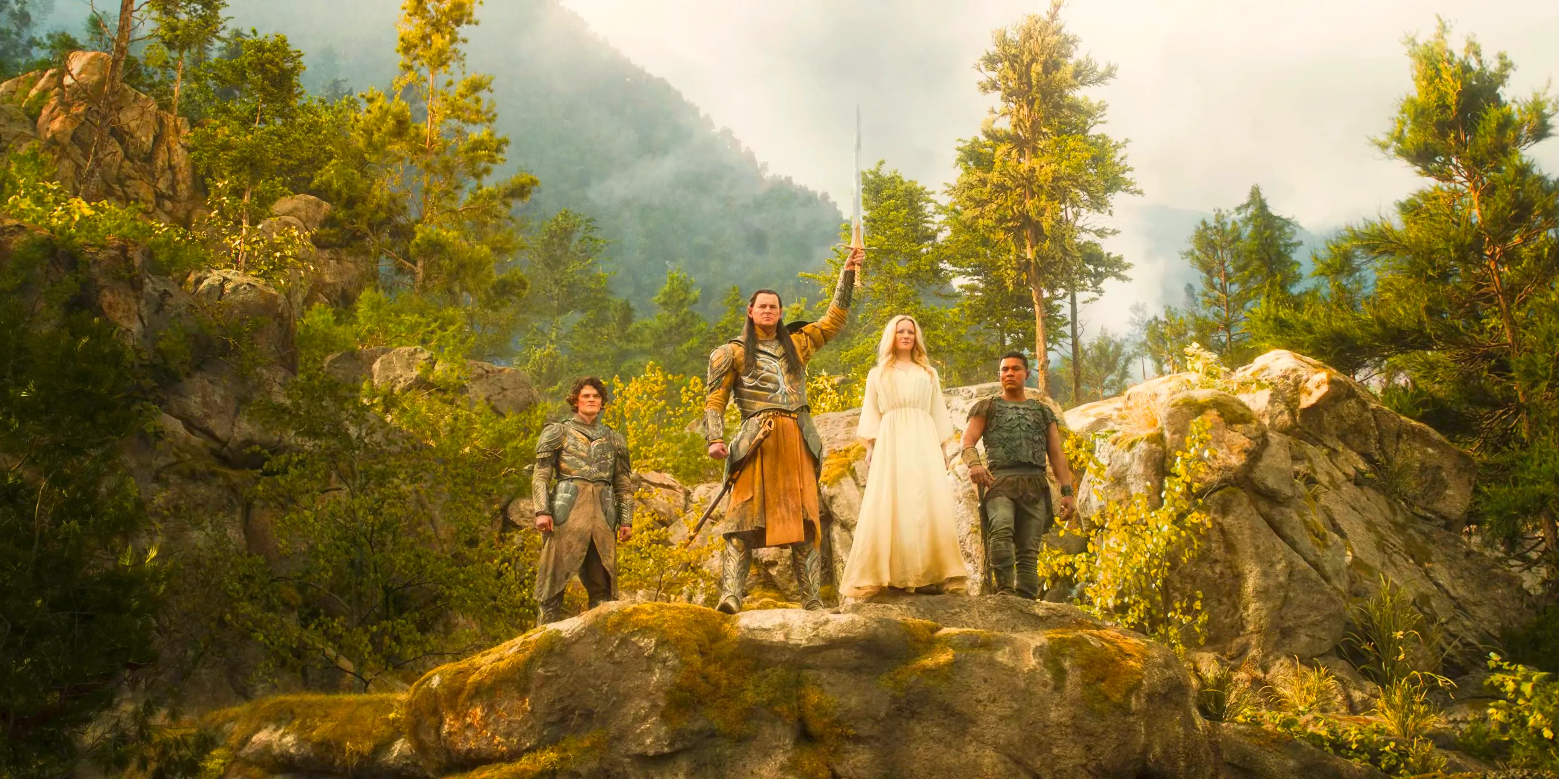 Gil-galad, Galadriel, Arondir and Elrond looking over the Elven population from a higher cliff in the Valley of Imladris in The Lord of the Rings: The Rings of Power Season 2 Episode 8 Image