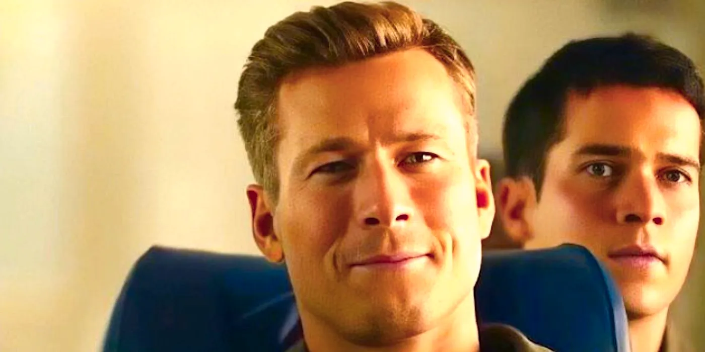 Glen Powell's Hangman smiles while sitting in class in Top Gun Maverick Image