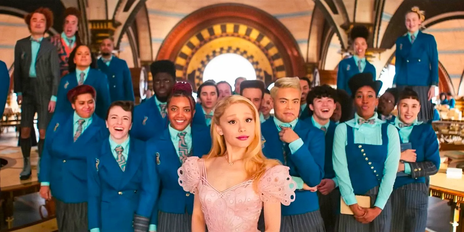 Glinda (Ariana Grande) with some students from Shiz University behind her in Wicked  Image