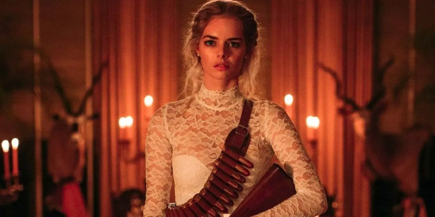 Grace (Samara Weaving) armed for the hunt in Ready or Not wearing her bridal dress Image