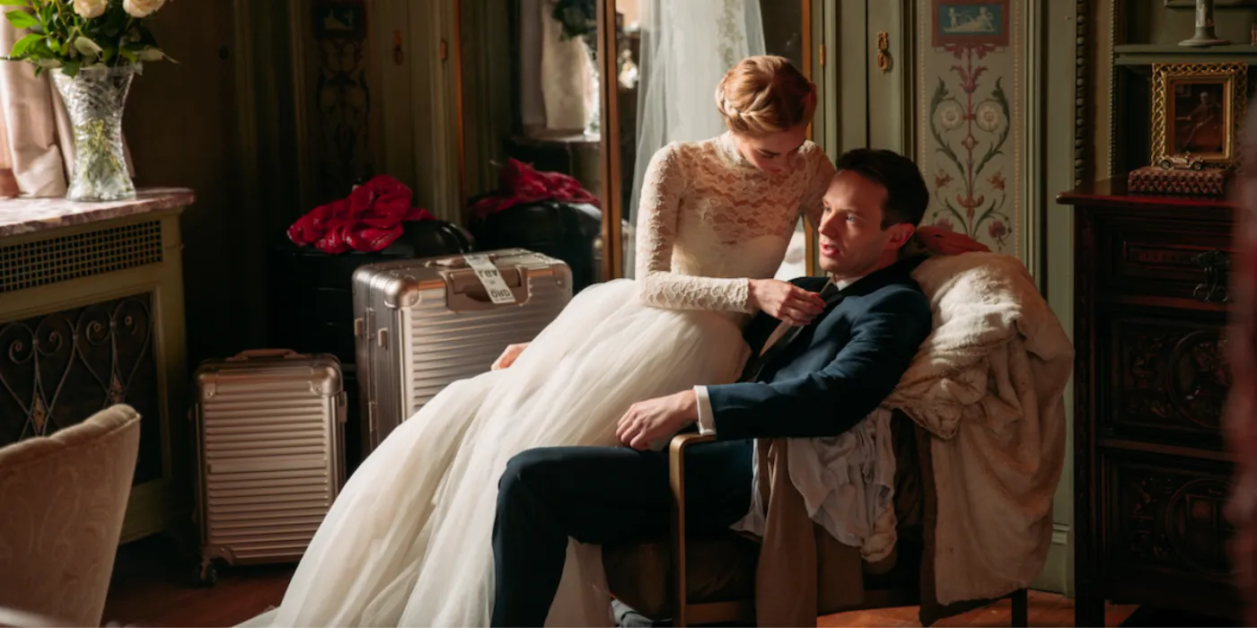 Grace (Samara Weaving) consoling Alex (Mark O'Brien), both dressed for their wedding in Ready or Not Image