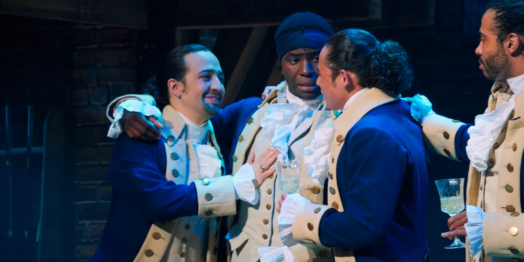 Hamilton embraces his friends in their blue coats in Hamilton Image