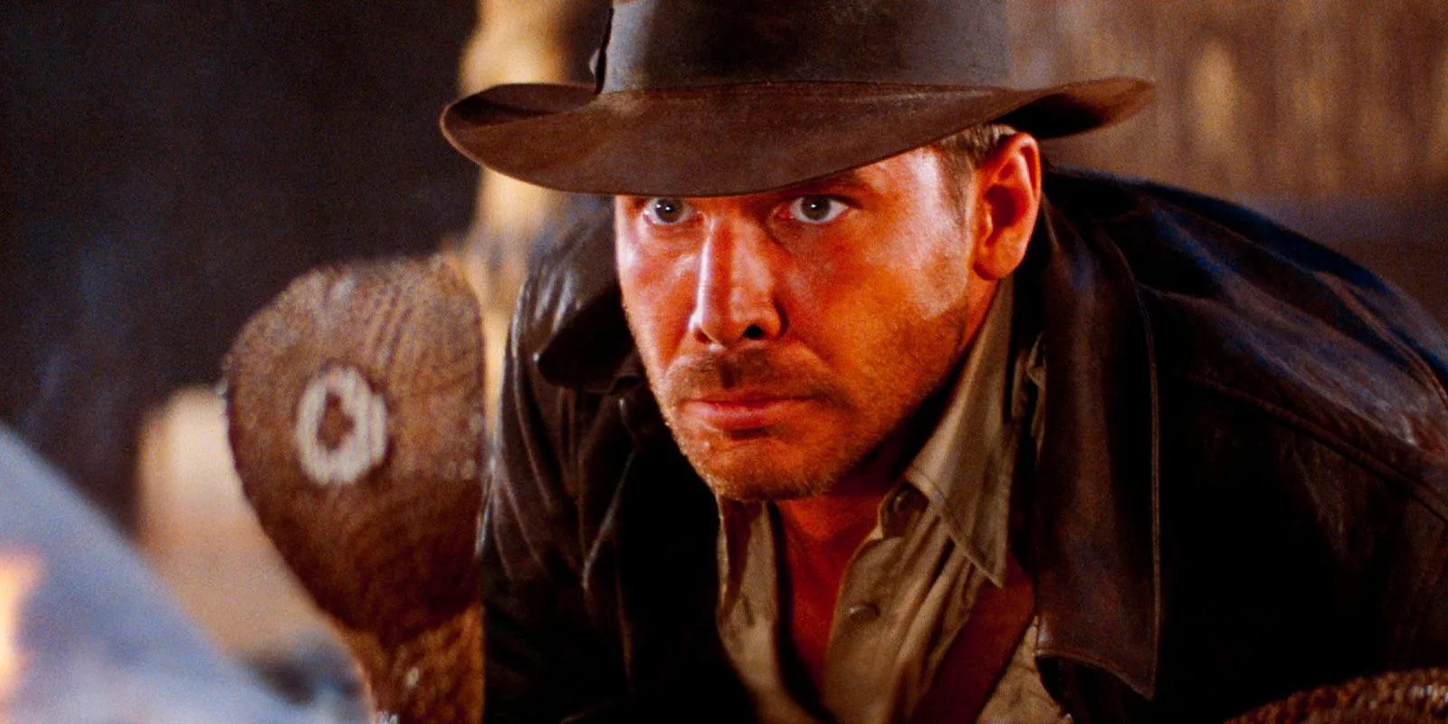 Harrison Ford as Indiana Jones terrified as he looks at a cobra in Raiders of the Lost Ark Image