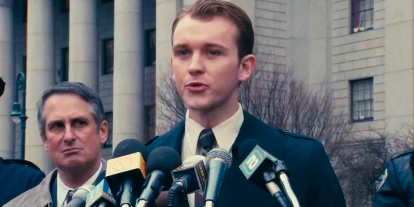 Harry Lawtey as Harvey Dent speaking at a conference Image