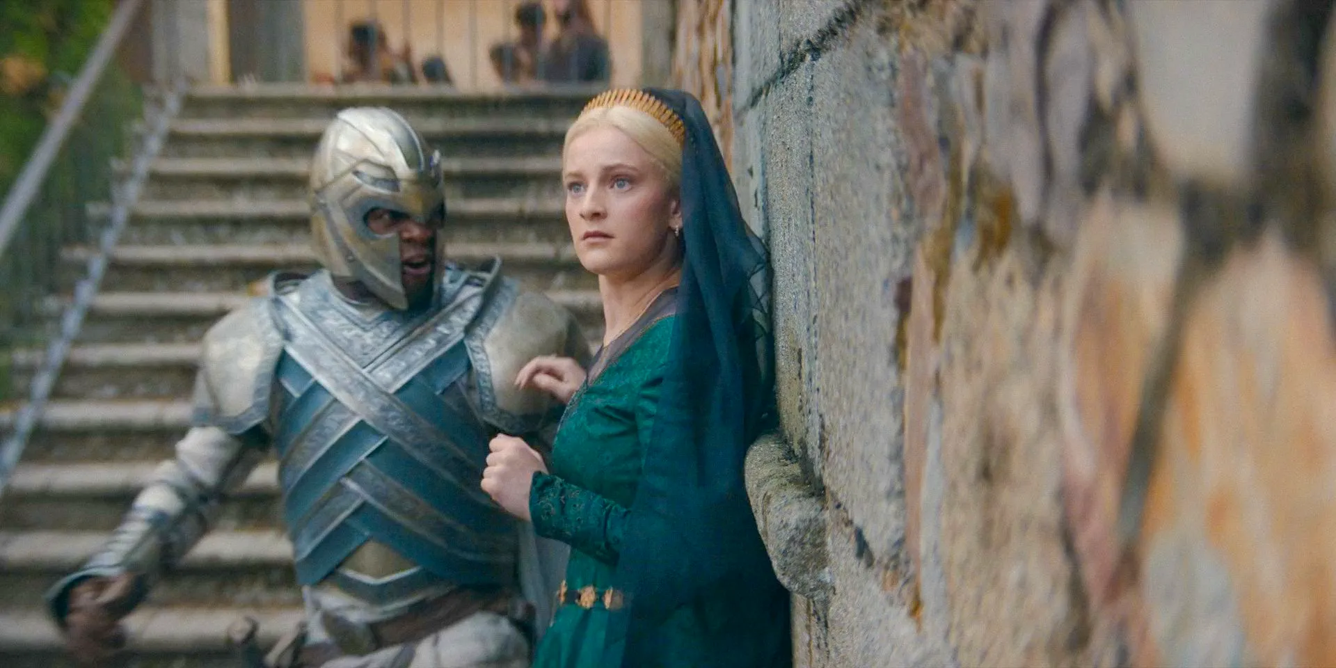 Helaena (Phia Saban) frightened by the crowd as a guard escorts her to the carriage in House of the Dragon Season 2 Episode 6 Image