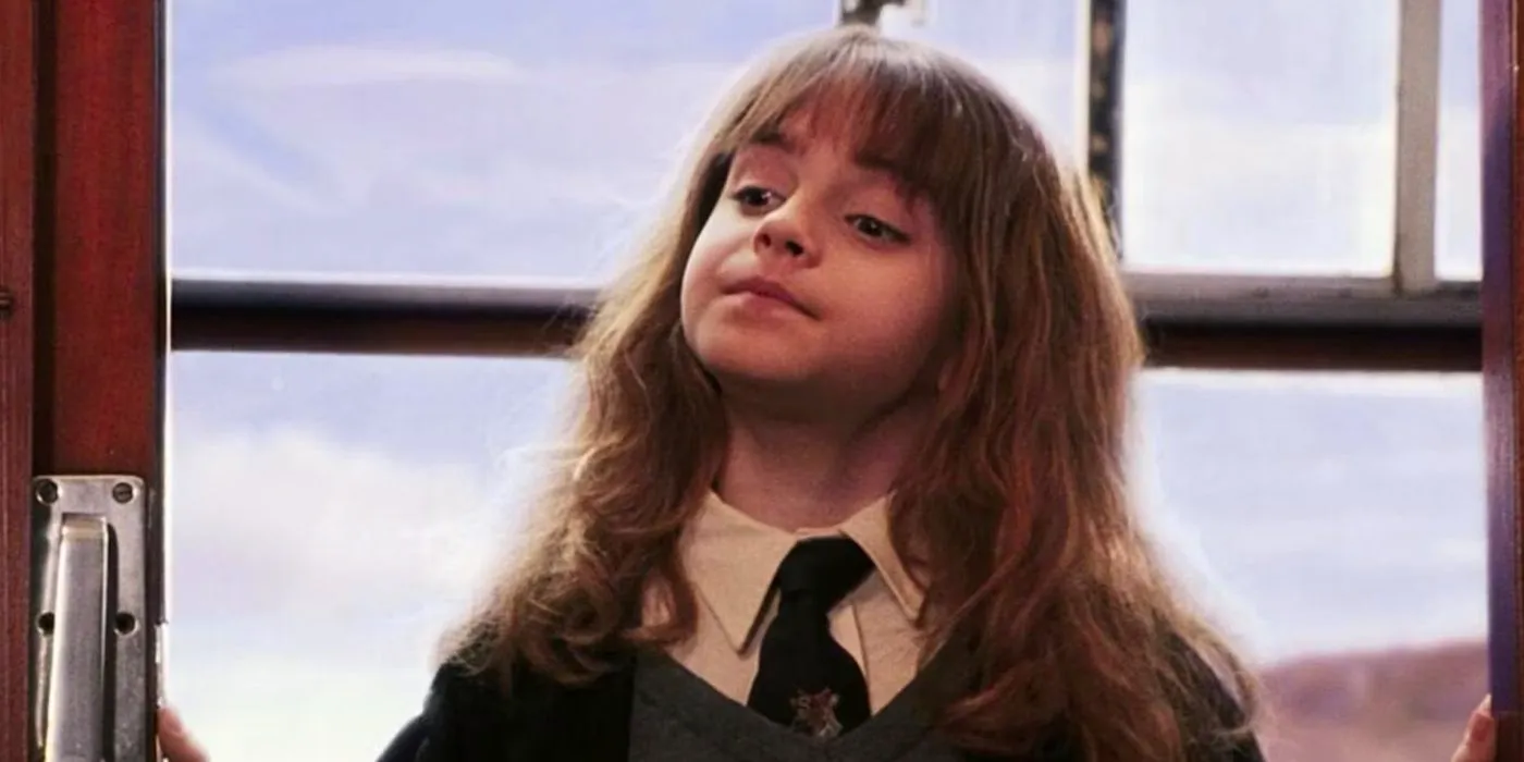 Hermione (Emma Watson) looking smug on the Hogwarts Express in Harry Potter and the Sorcerer's Stone. Image